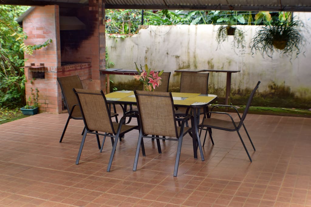 A lovely tropical garden back patio area for Al Fresco Breakfasts and hanging out during the day & into the evening. There's a hammock & trampoline. (Smoking is allowed here!)