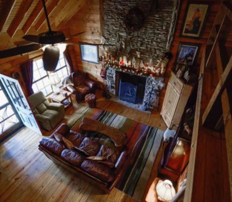 Living room with a large wood burning fireplace.