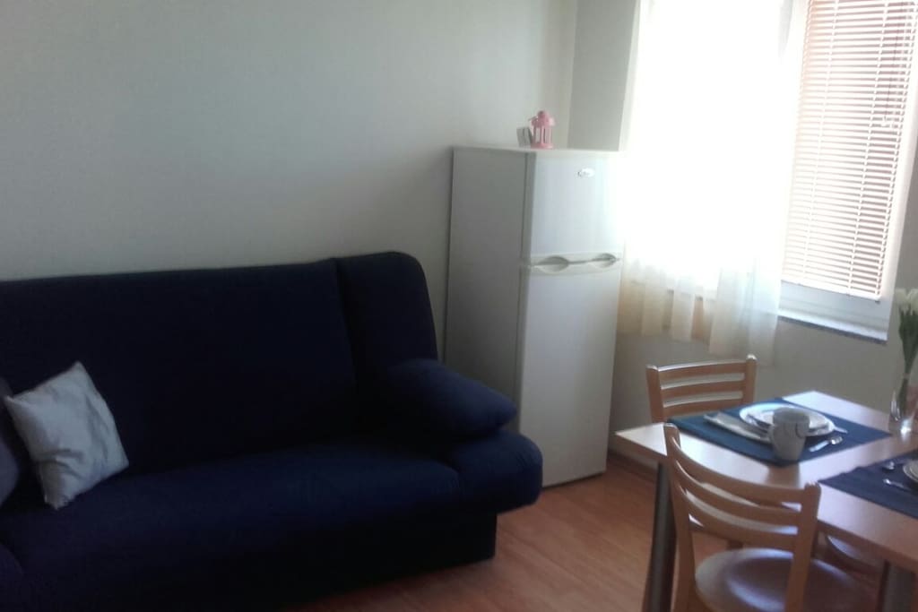 Dining room with sofa bed and kichen