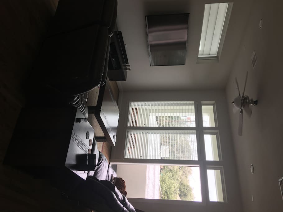 Living with 70" and balcony.