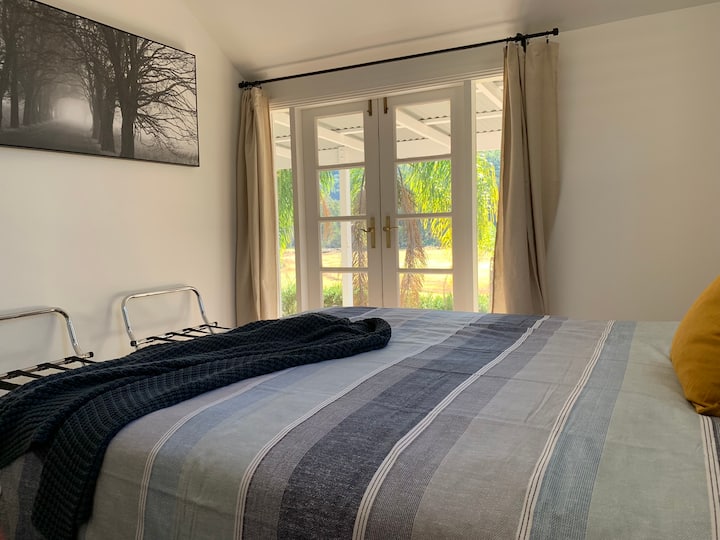 Bedroom one with doors opening to balcony. 