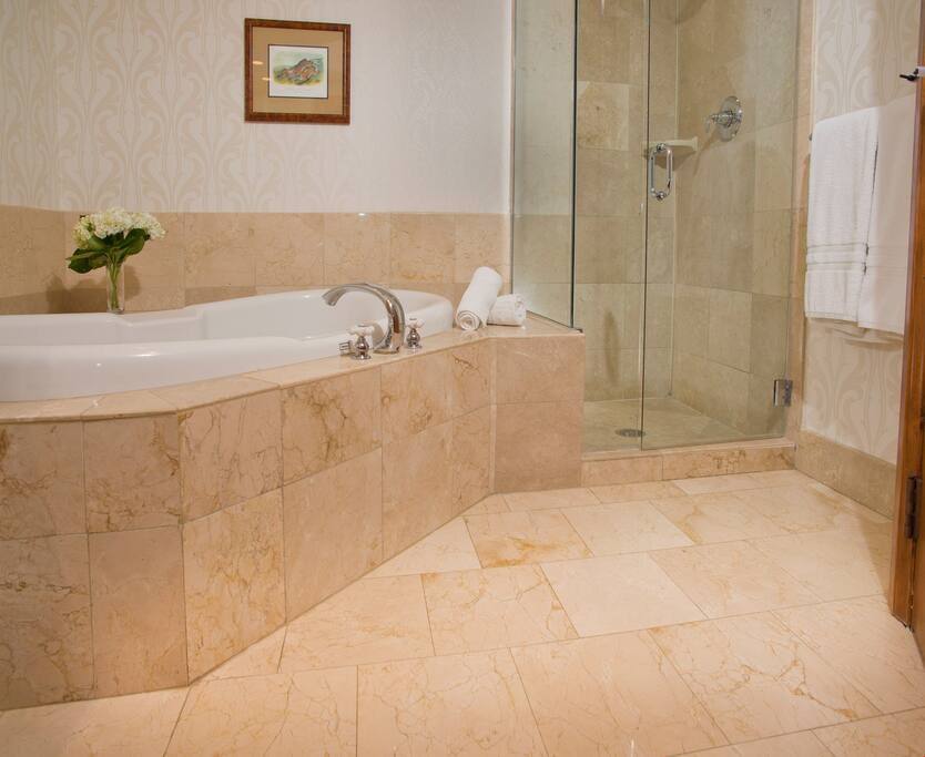 Prepare for the day in the luxurious marble bathroom.