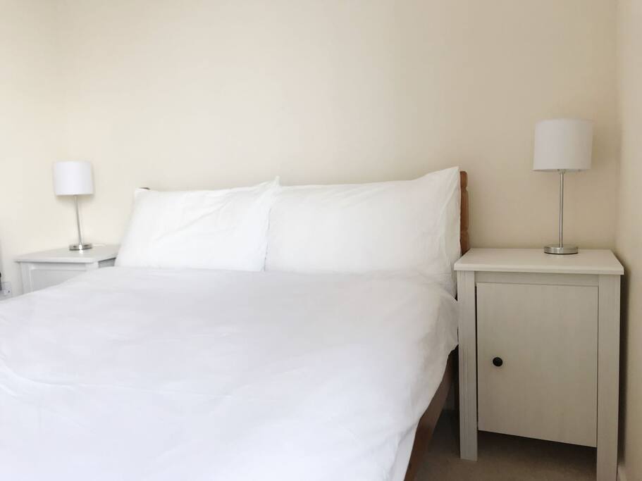 Comfy double bed with two bedside tables and lamps