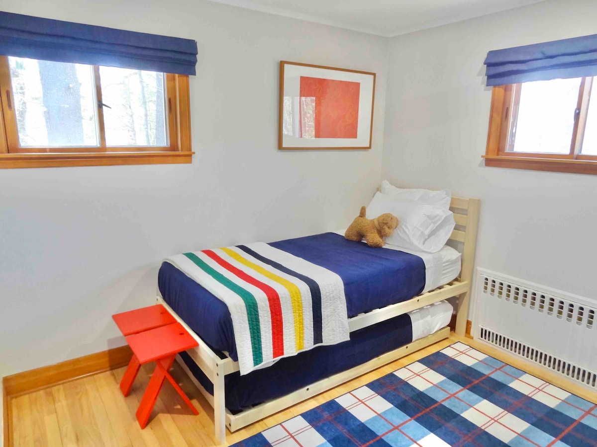 The twin bedroom on the main level has one XL twin (with 10" mattress), and a regular-size twin trundle (with 8" mattress). The XL twin could sleep an adult or child, but the trundle is intended to be a kid's bed. 