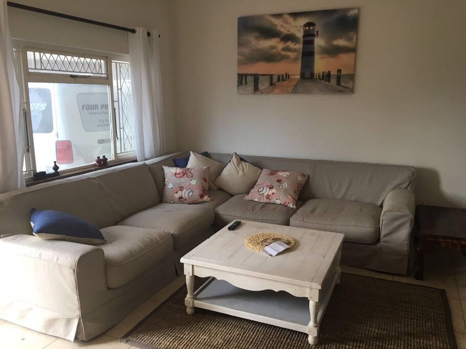 Big L shape couch in lounge with air conditioning