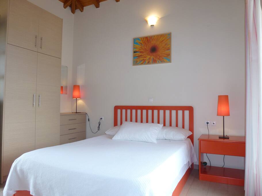 Bedroom on upper floor with an en suite bathroom. The bedroom opens up into two balconies on either side. The wardrobe and cupboard provide plenty of storage space.
