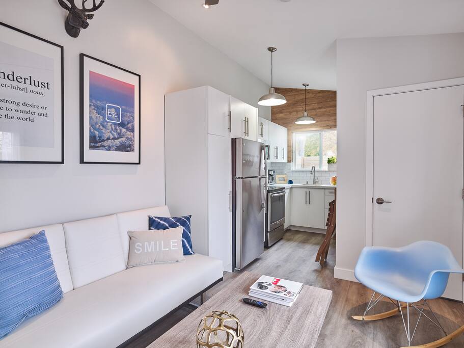 Refreshing view of the living area and kitchen. High ceilings and light colors opens the space.