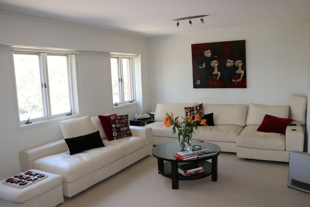 Spacious living area with sun-filled room overlooking the park and harbour
