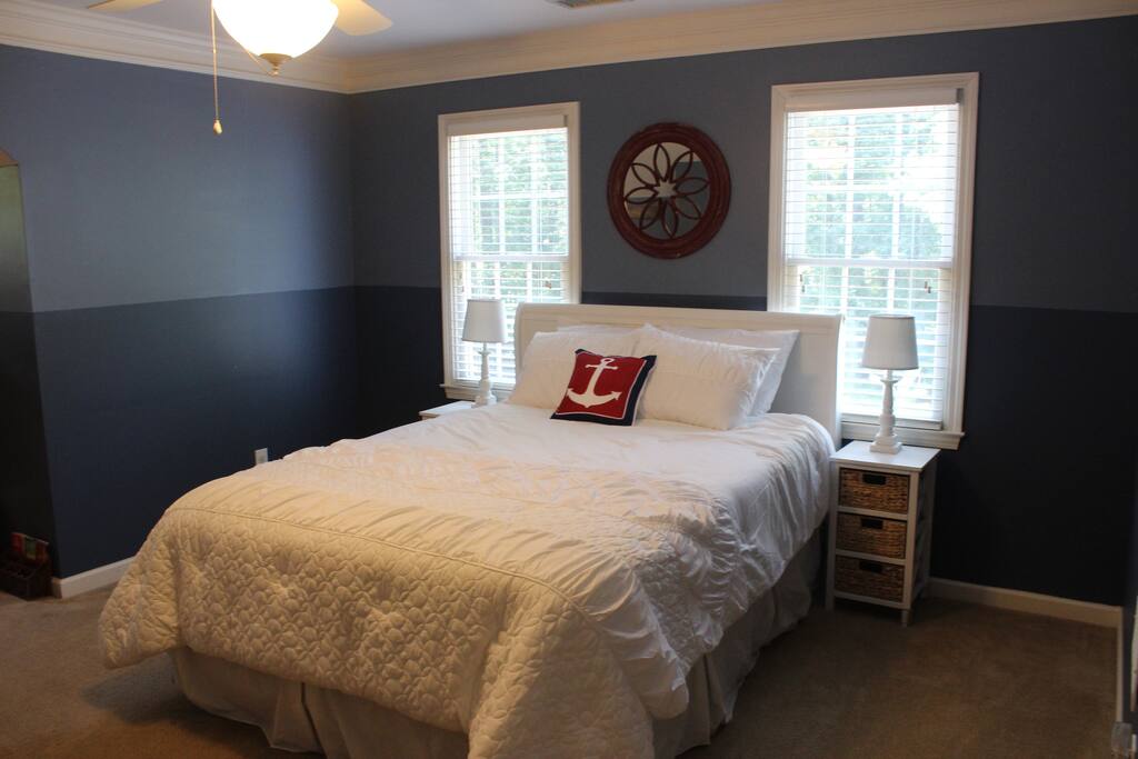 Nautical suite queen bed.