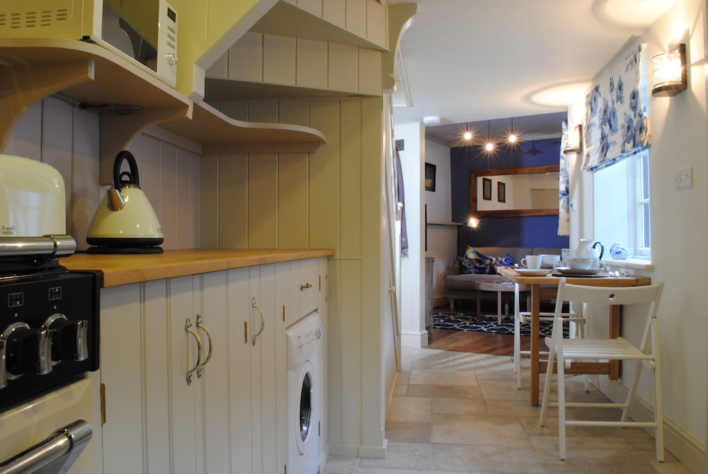 Custom built wooden kitchen, past the dining space at the foot of the stairs into the cosy sitting room
