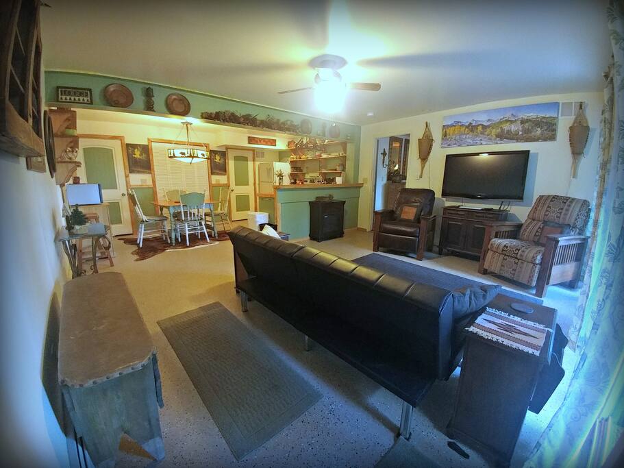 Living room with door to King bedroom + bathroom