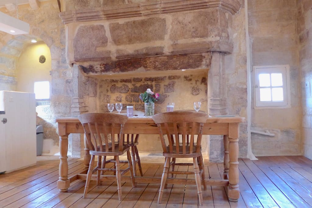 Dining table in front of the 13th Century fireplace.