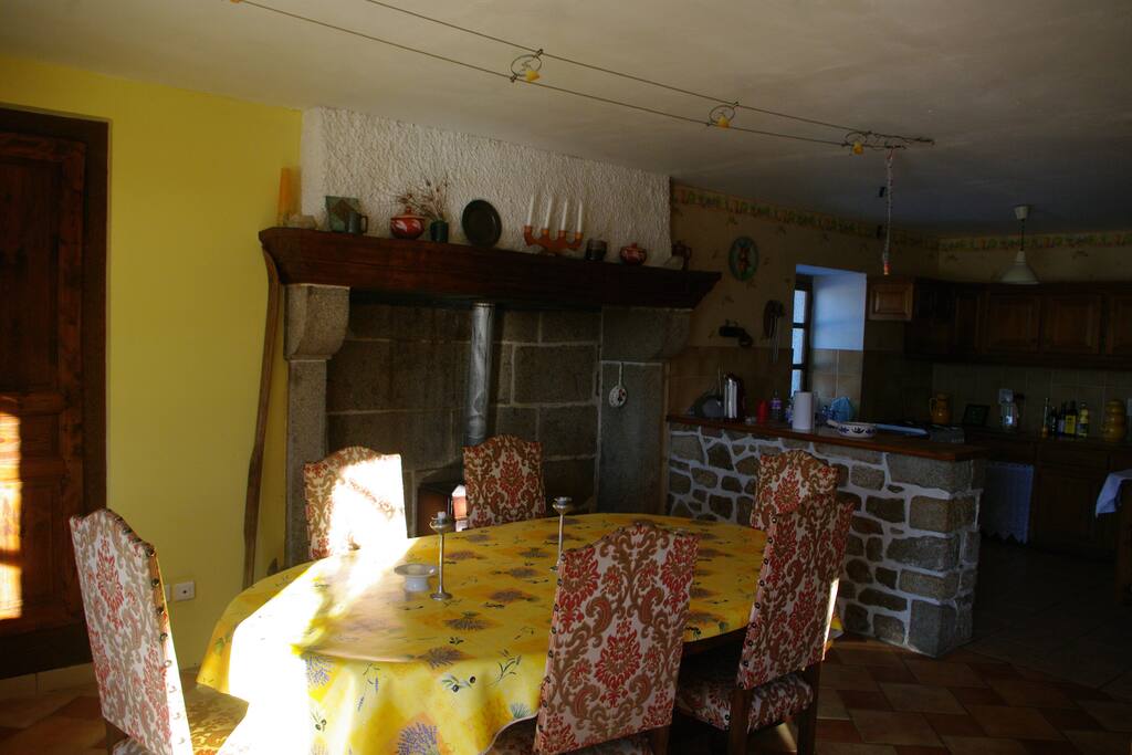 Dining room with kitchen in background