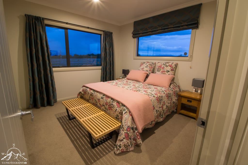 King-sized bedroom with views of the mountains.