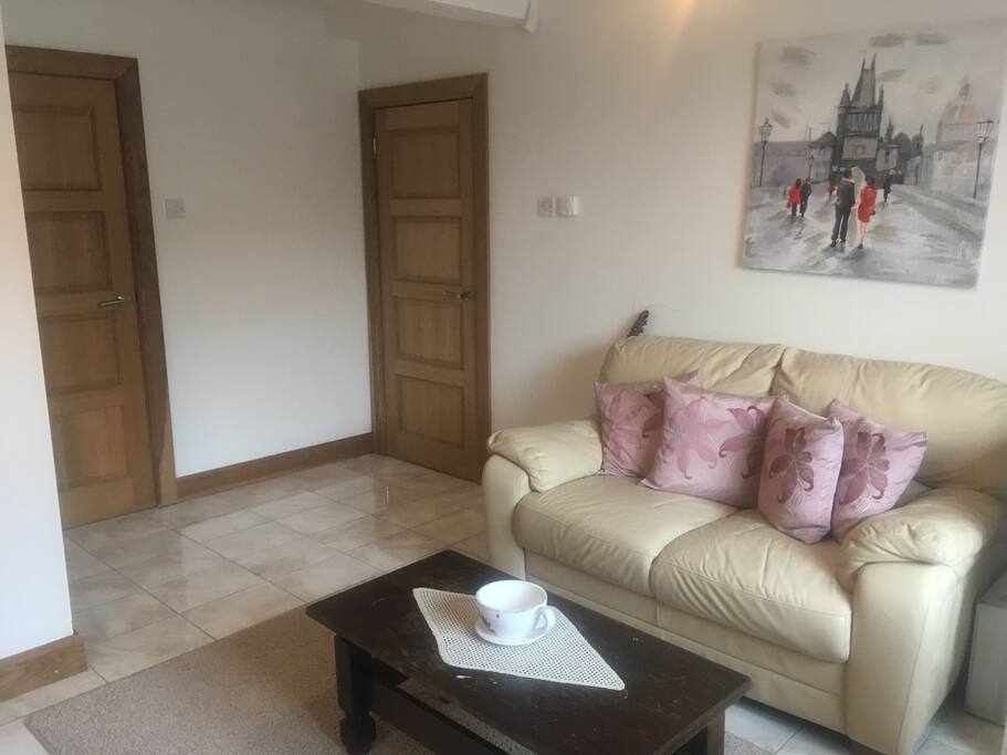 Master bedroom with comfortable sofa and tea and coffee facilities