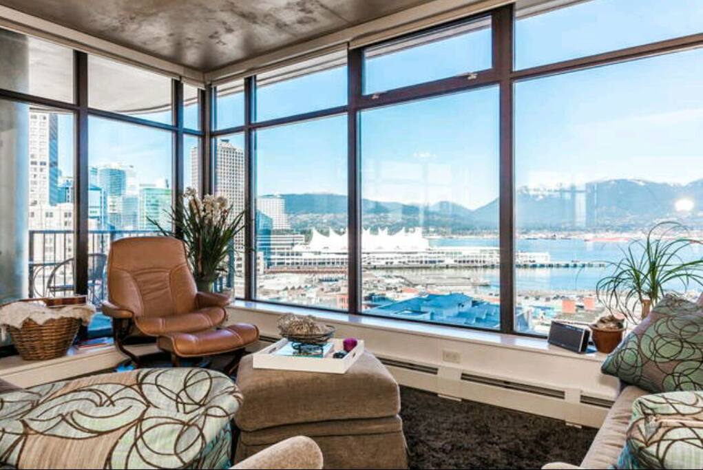 View of Canada Place, North shore mountains, aqua bus, heli pad, sea planes, cargo port, bald eagles, whales. One of the most active and best views in Vancouver!