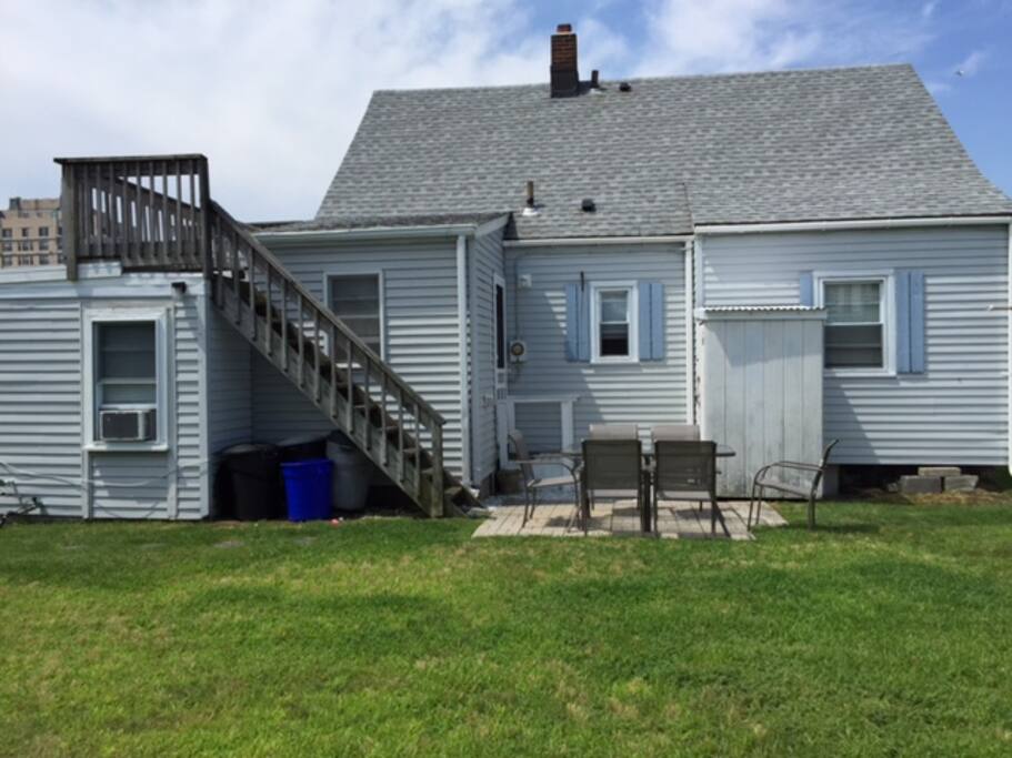 Large backyard with patio and gas grill and outdoor shower