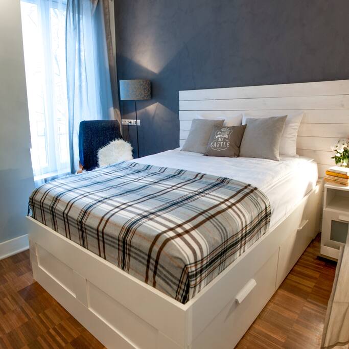 Cosy bed with a wooden balcony