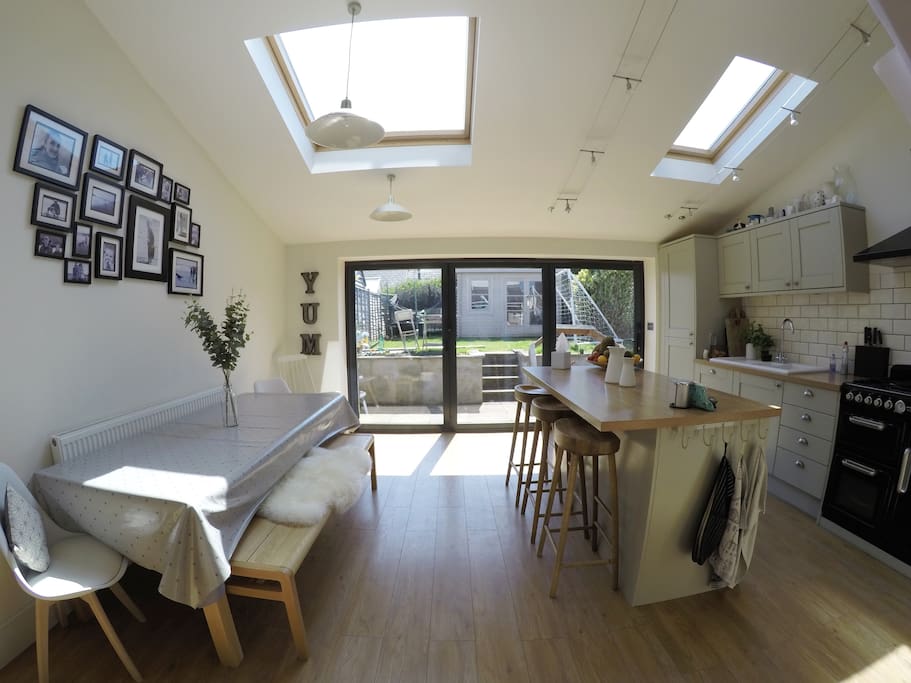 Spacious open plan kitchen with bi-fold doors opening onto the garden