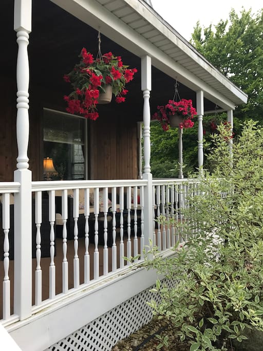 Beautiful wrap-around porch with comfy furniture