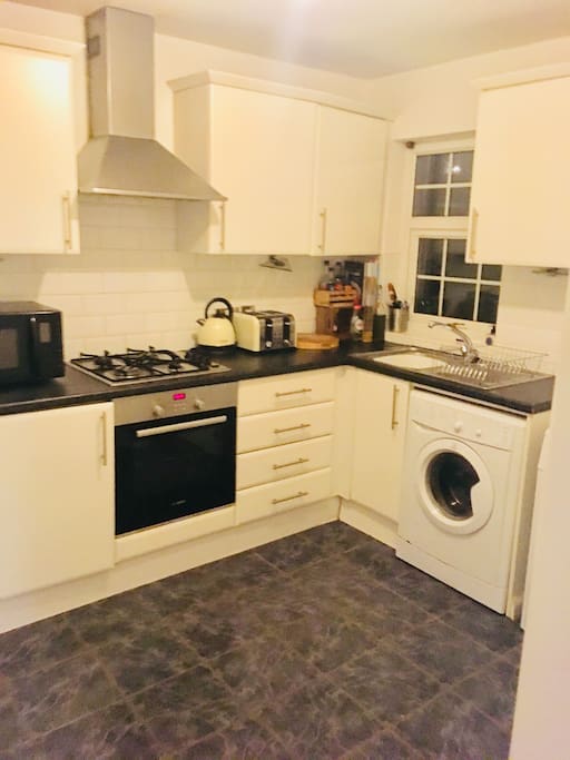 Kitchen with fridge freezer, tumble dryer, washing machine and oven