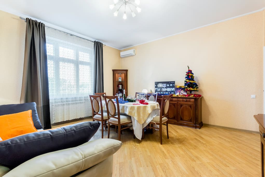Living room has a large dining table and new, white leather sofa-bed (sleeping place 160x200)