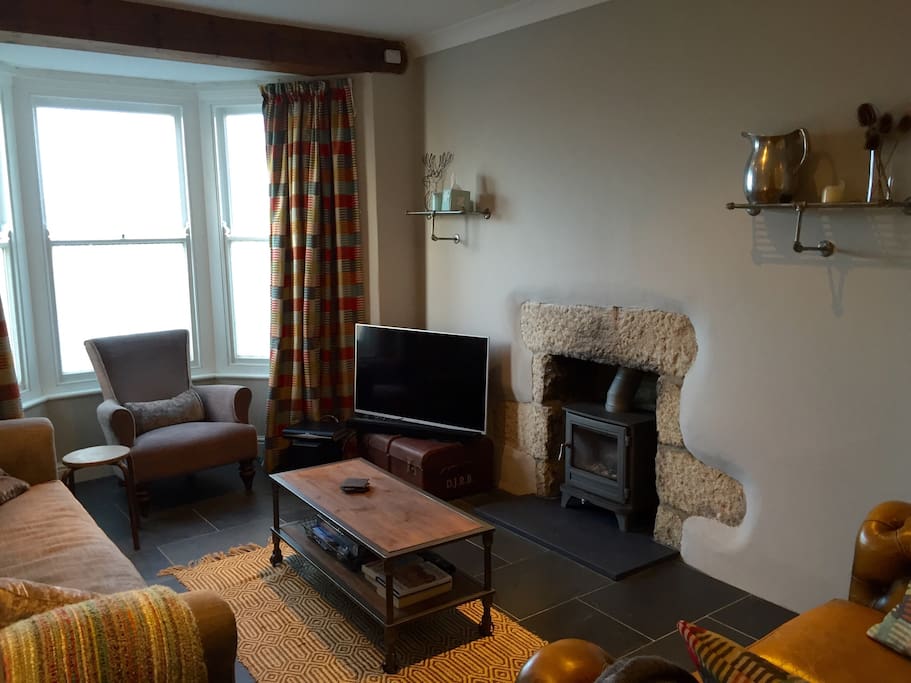 Spacious living space with log burner.