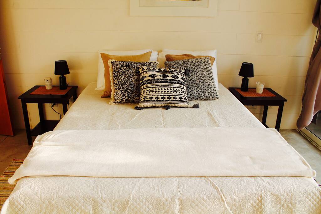 The master bedroom has a queen sized bed, ensuite bathroom, ample closet space, and a glorious private patio to escape the sun.