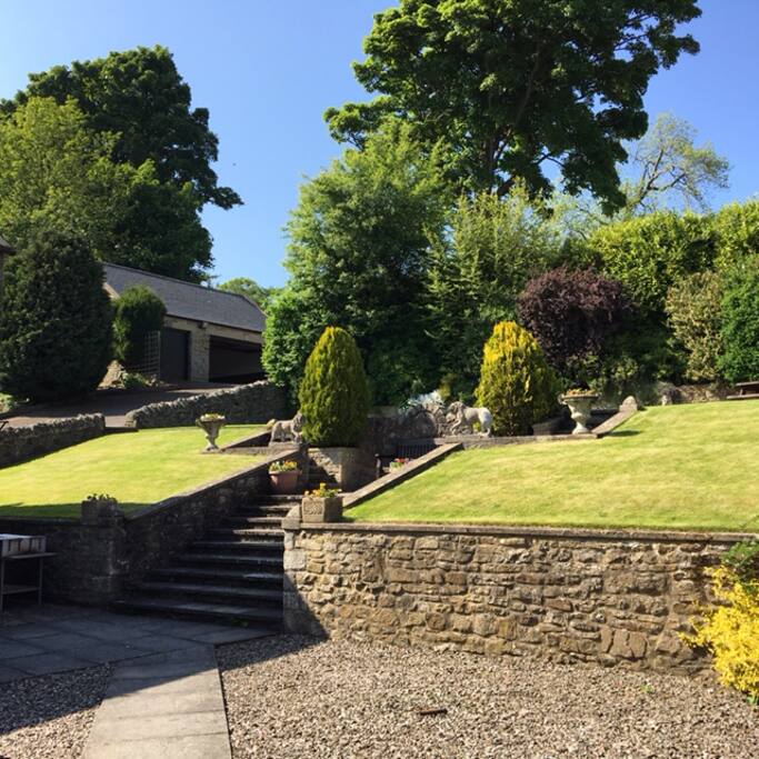 Gardens with garage beyond