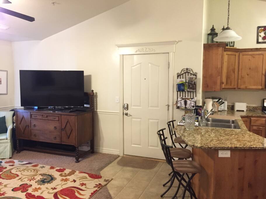 Front door, the front room and kitchen.