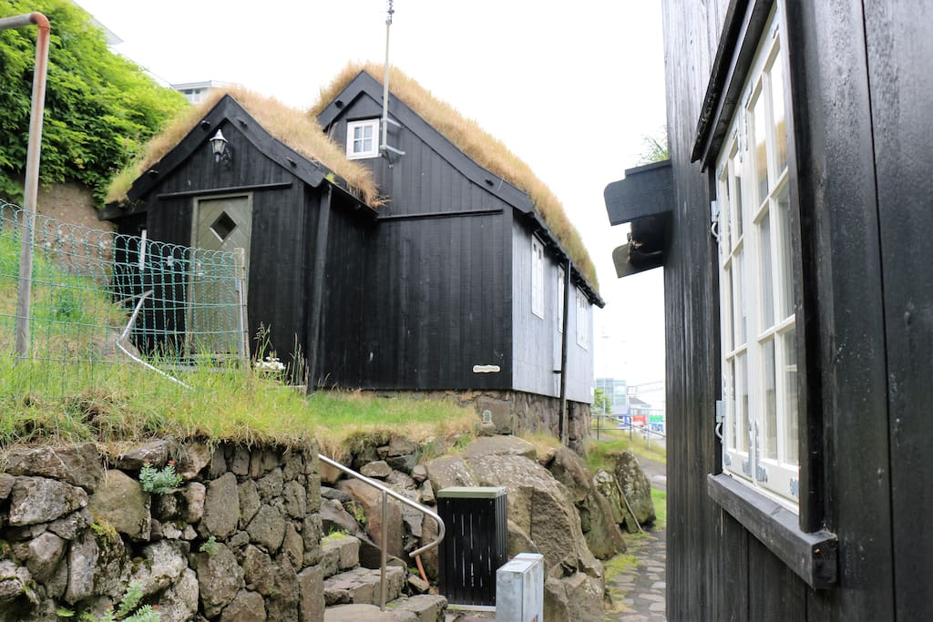 The grass roofed traditional Faroese house is built on a rock.