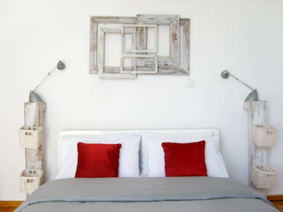 The double bed with the artsy bedside stands and the artwork above