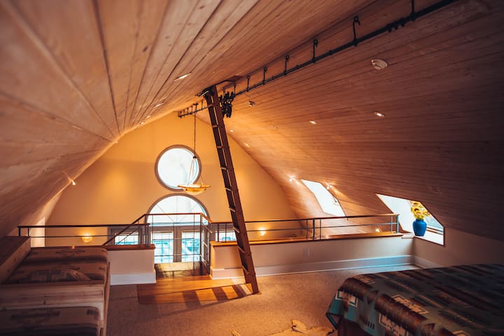 The Barn: Loft style master bedroom with access to authentic cupola