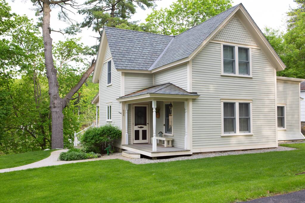 STREET SIDE view of the cottage. The spring gardens are getting ready to burst forth with their colorful perennials. BACK VIEW of the cottage is the WATER VIEW!