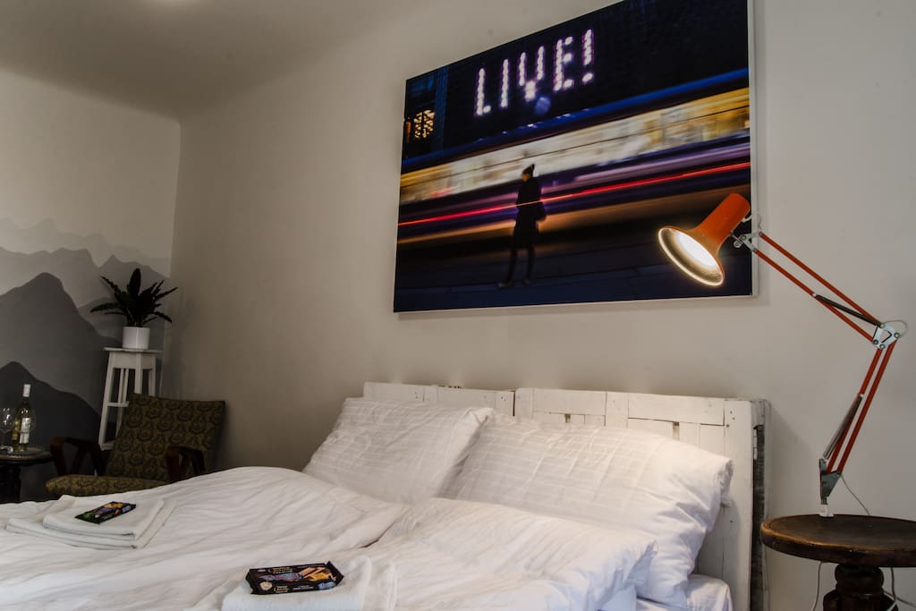Bedroom with sitting area in background.