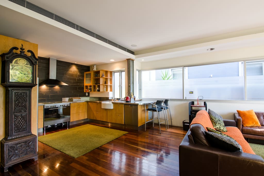 Modern kitchen with breakfast bar, large gas cooker and Miele dishwasher