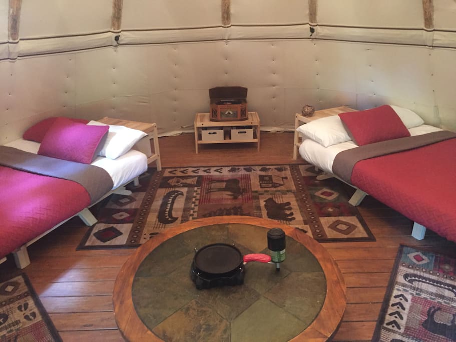 Equipped with 3 beds (2 queen and 1 full) this spacious tipi is ready for a couples retreat or the family. Table top propane stove is shown in the middle of the table with cast iron pan for your cooking convenience!