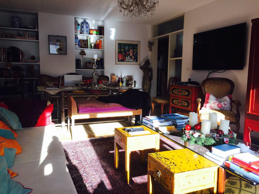 The living room has a large flat-screen TV with cable.