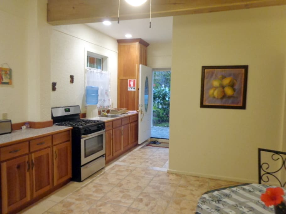 Full size stove/oven in kitchen. Front garden view with open, screened door!