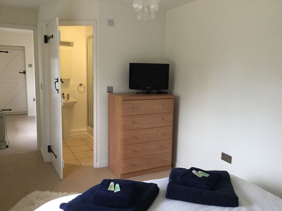 Bedroom with ensuite shower, king size bed and freeview television