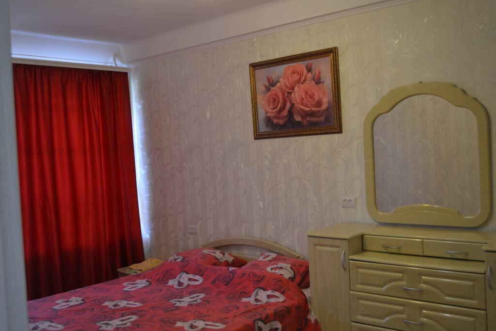 This is a bedroom. A bed with an orthopedic mattress and a TV. There is a balcony where you can go out to breathe air or smoke