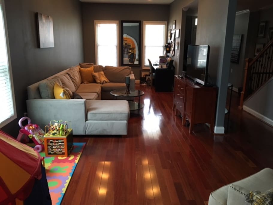 Living room with TV, desk/work space and play area
