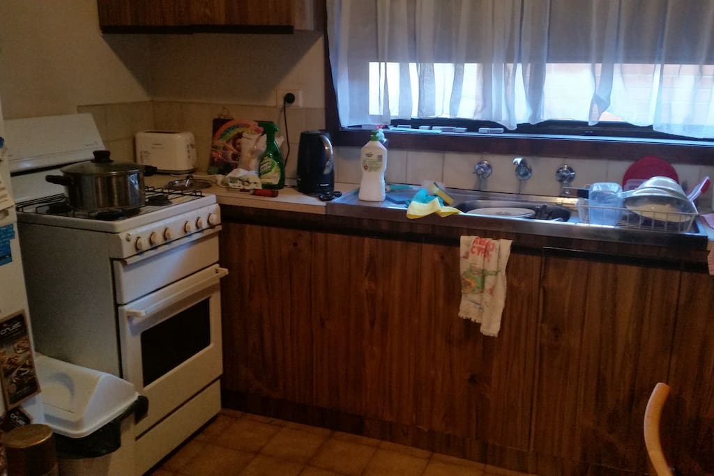 Kitchen with microwave, oven and stove and fridge