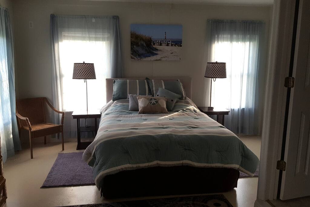 Bedroom includes a queen bed, large dresser and closet, and usb chargers in the night stands.