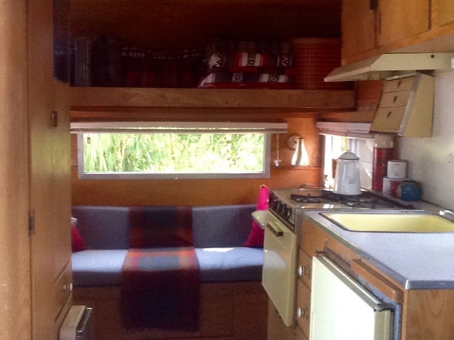 Gas stove, fully stocked kitchen, sink with running water, ice box.
