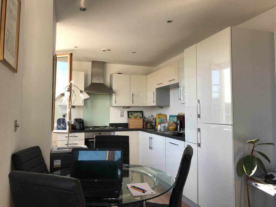 The kitchen area showing the fridge/freezer and dining area. There is a dishwasher and microwave as well as a full size gas cooker of course