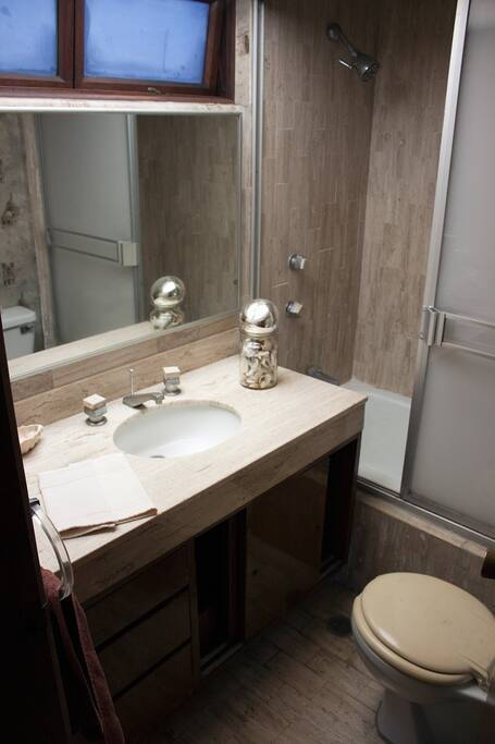 En-suite bathroom with tub and shower.