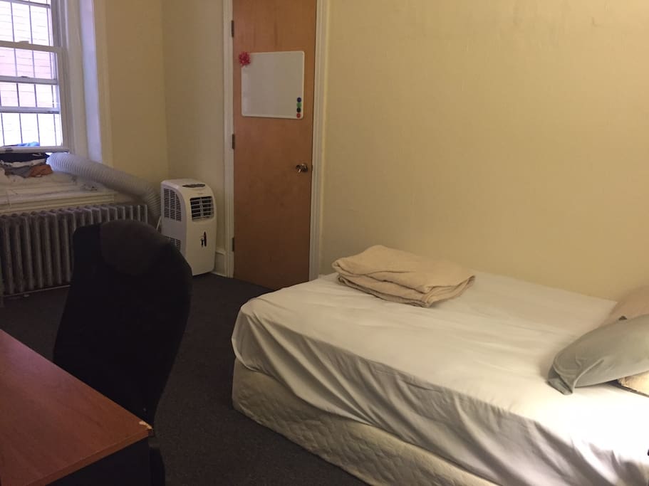 Full bed, large desk, and a powerful AC unit.