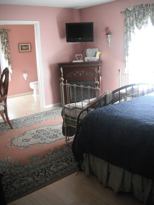 Electric fireplace, table and chairs for in room work or simple dining.