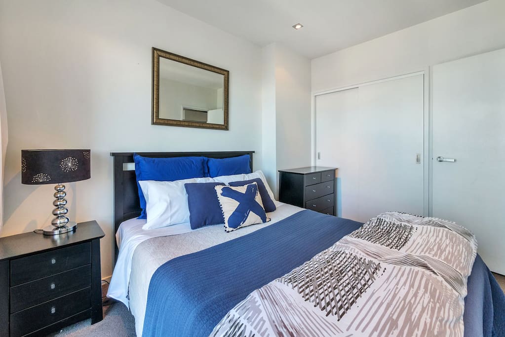 Bedroom has black out curtains for a good nights sleep on a comfy queen bed. Generous sized wardrobe plus drawers.